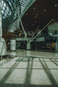 Interior view of Kuala Lumpur airport showcasing modern architectural design with sunlight reflections.